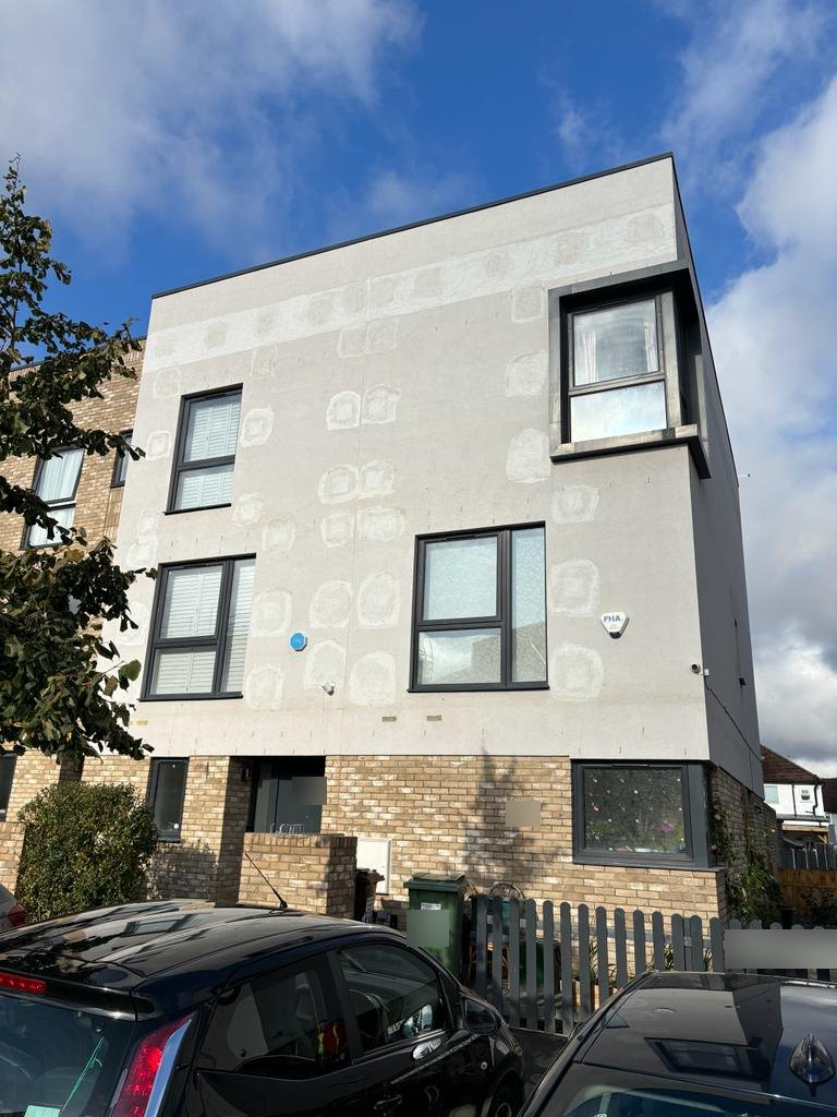 Rendered upper floors with rows of made-good investigation openings